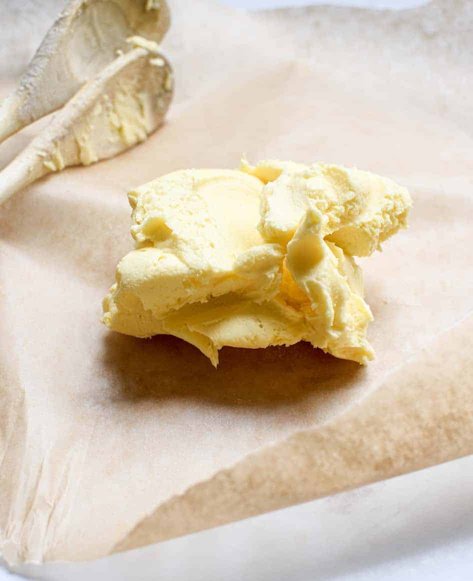 A picture of a clump of cultured butter on a bench that was made using a guide on how to make cultured butter.