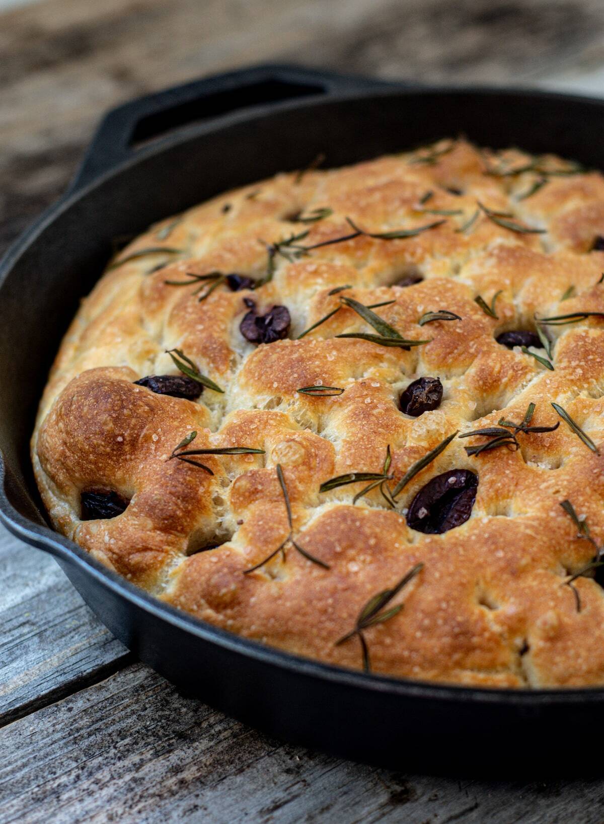 a circle black skillet with focaccia bread in it