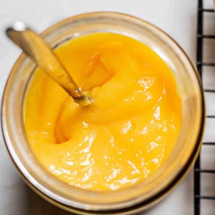 close up of a jar of microwave lemon curd.