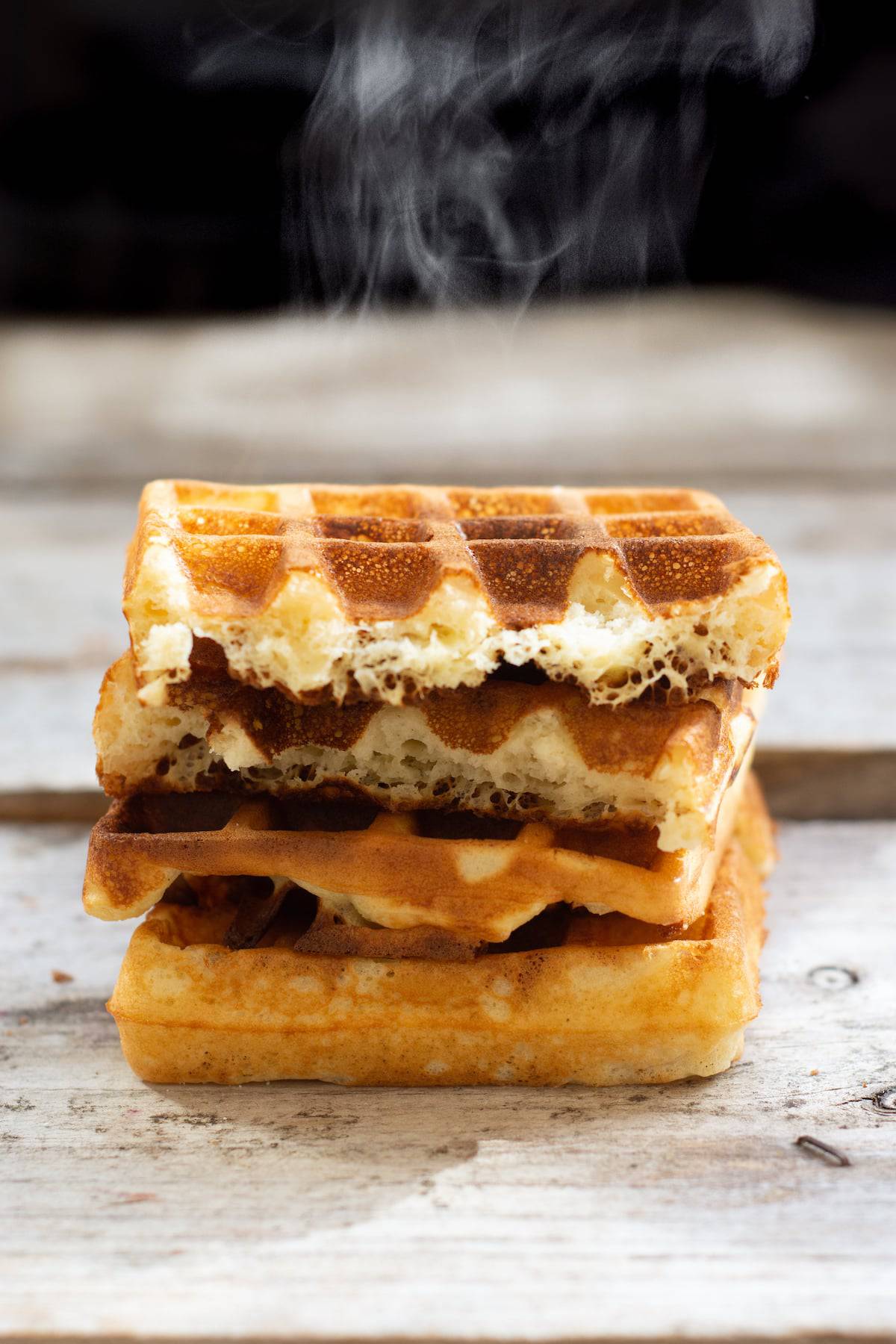 a stack of steaming waffles