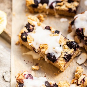 glazed blueberry crumble bars on brown paper