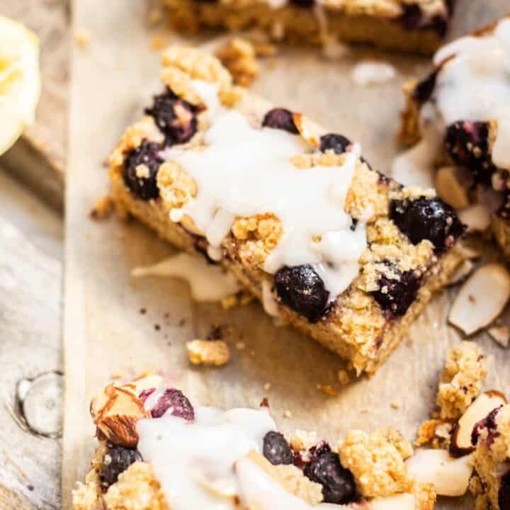 glazed blueberry crumble bars on brown paper.