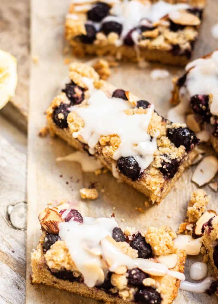 glazed blueberry crumble bars on brown paper