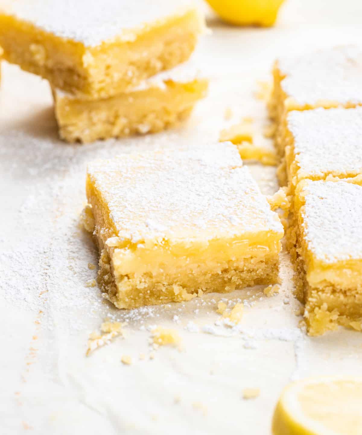 Stacked lemon bars on parchment paper