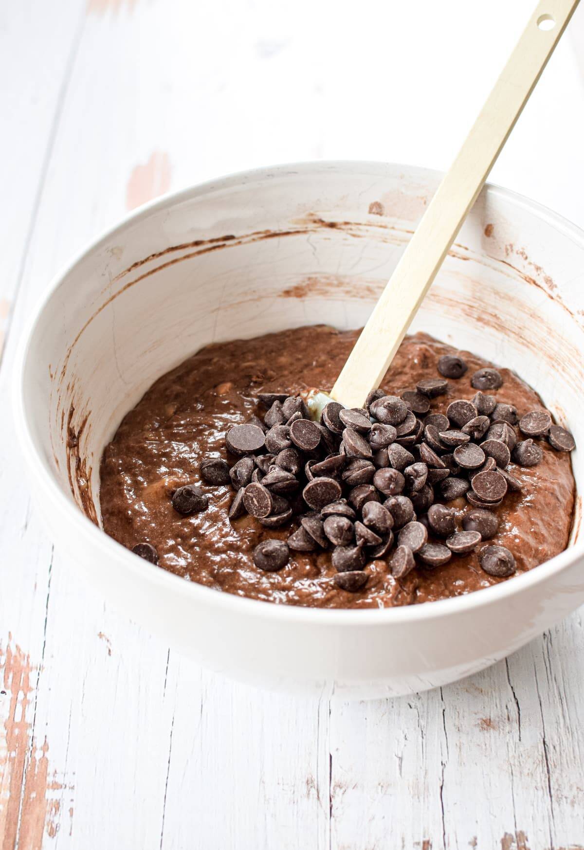 a bowl of chocolate batter with chocolate chips