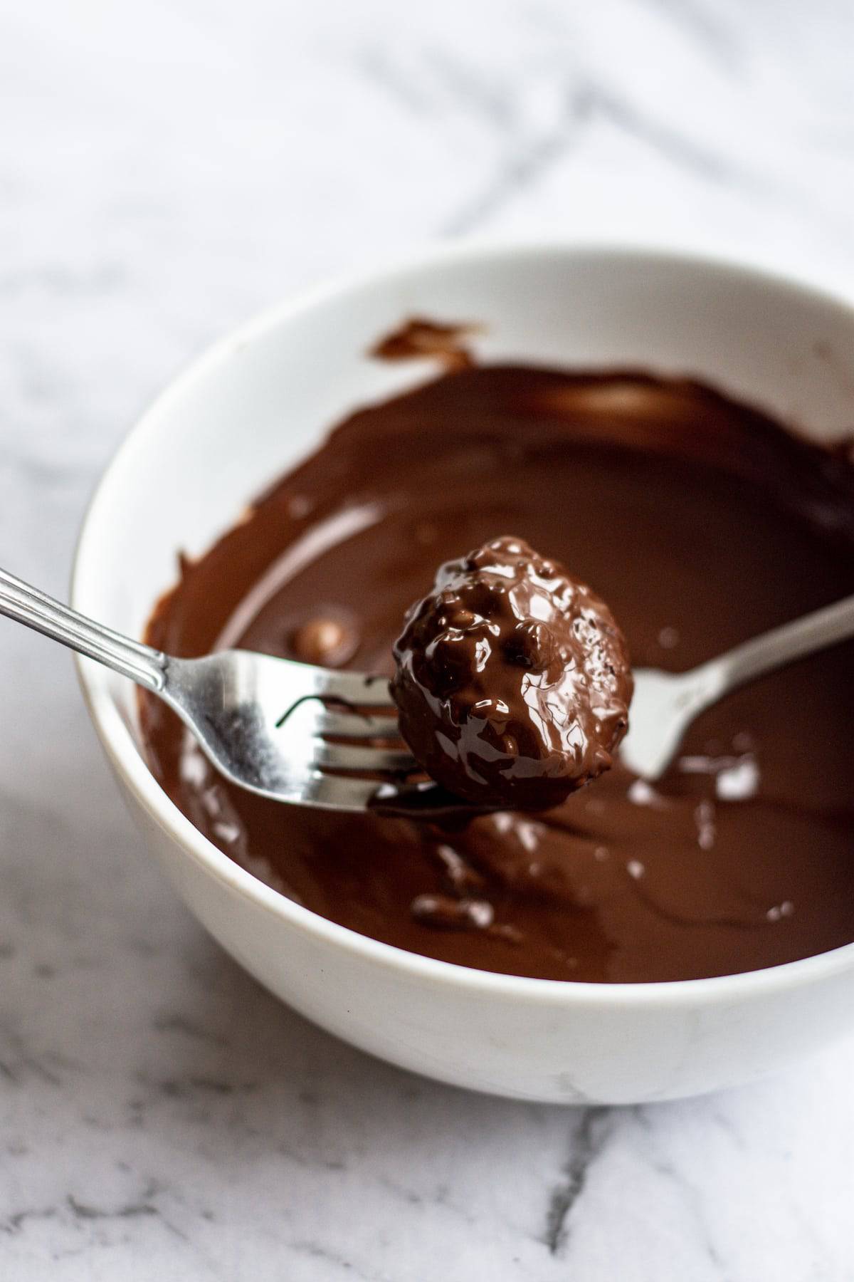 a chocolate covered truffle on a fork