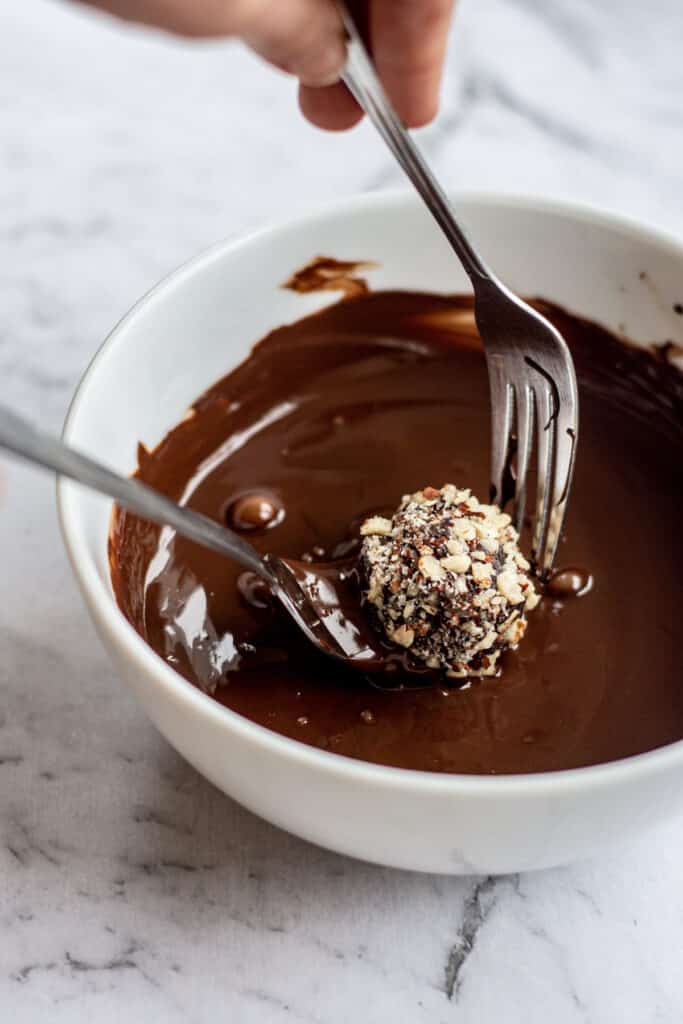 2 forks dipping a chocolate truffle into chocolate