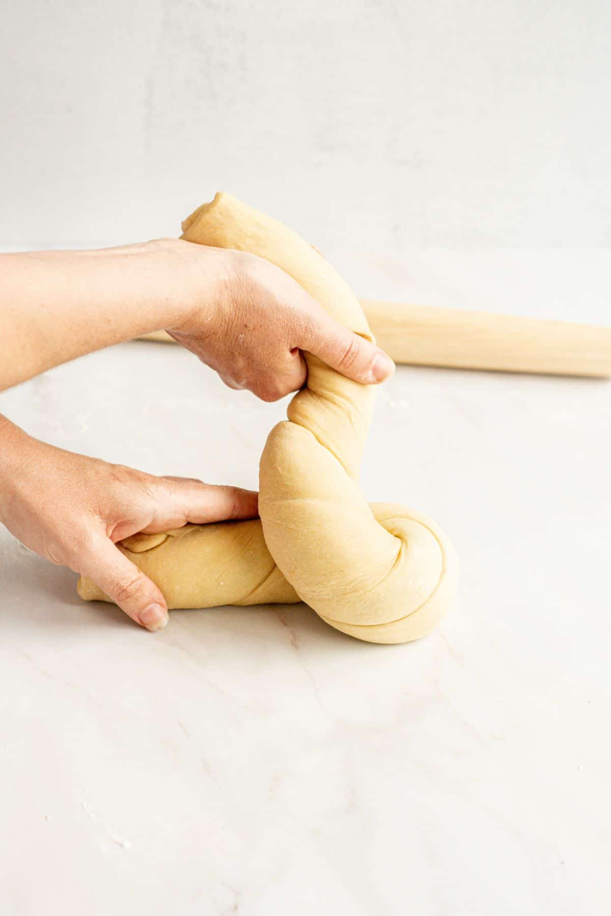 hand twisting dough.