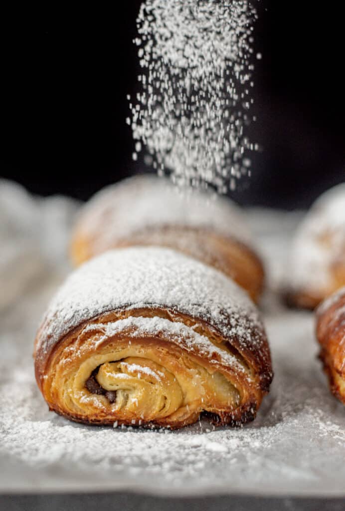 icing sugar dusting on sourdough chocolate croissant