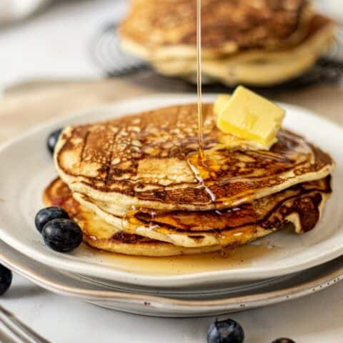 maple syrup drizzled on sourdough blueberry pancakes.