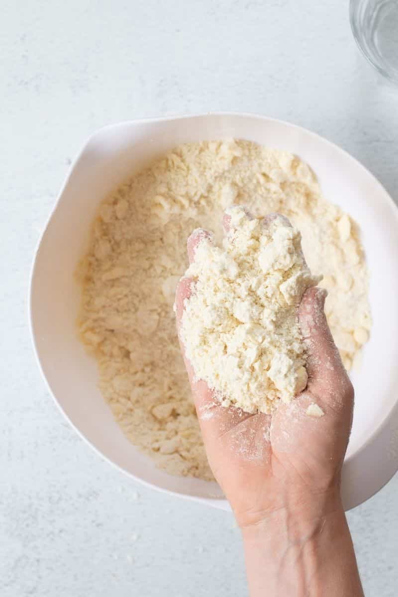 hand holding crumbled butter and flour