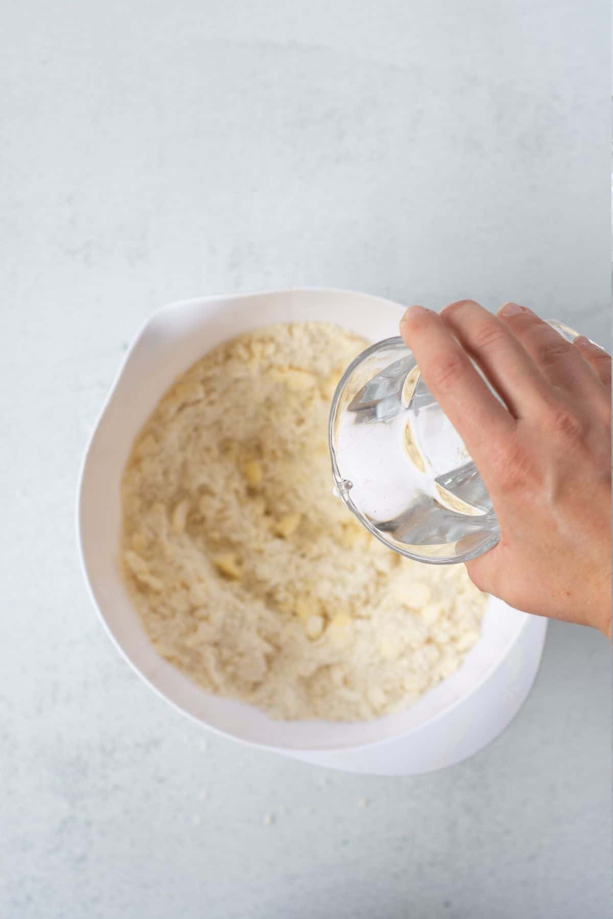 adding water to dough.