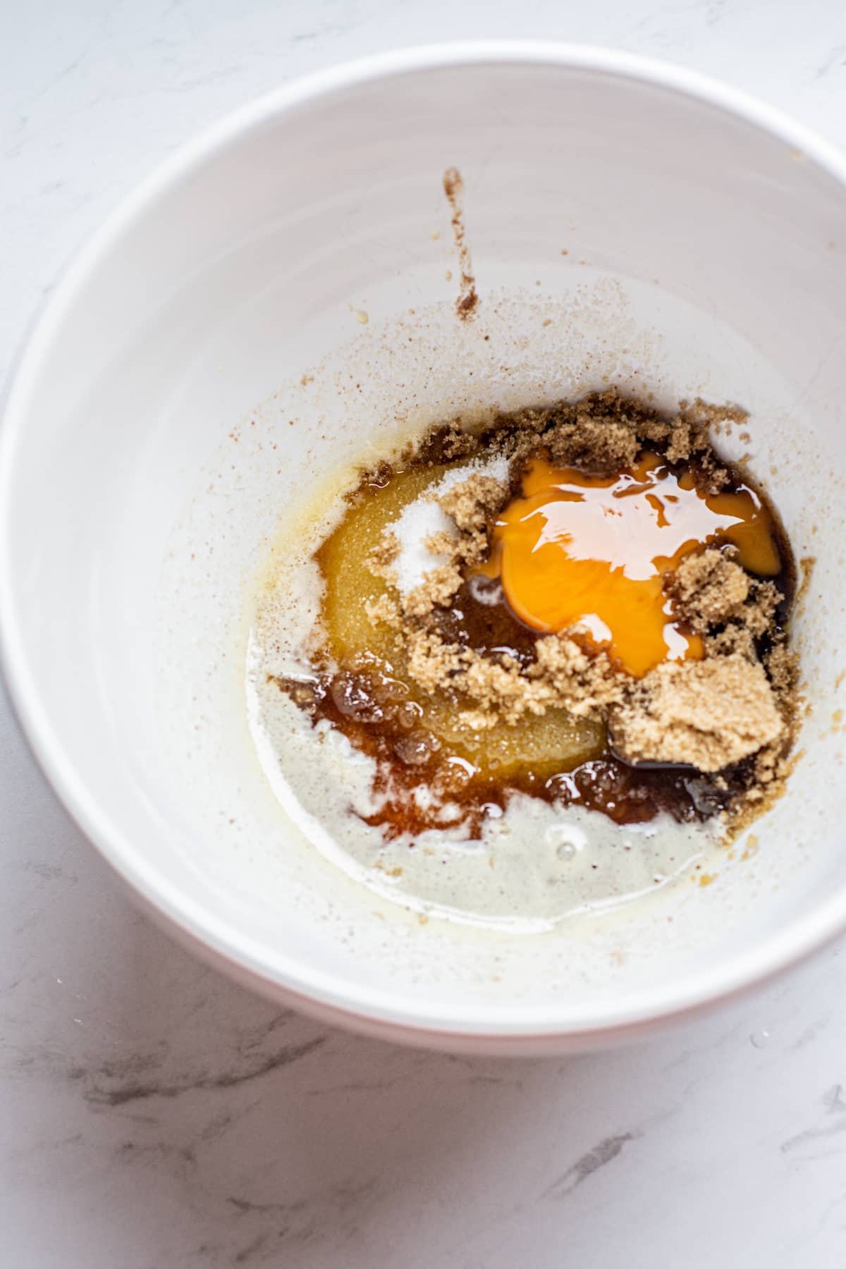 a bowl of sugar, brown butter and egg.