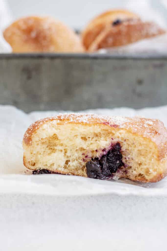 close up of ripped blueberry jelly donut.