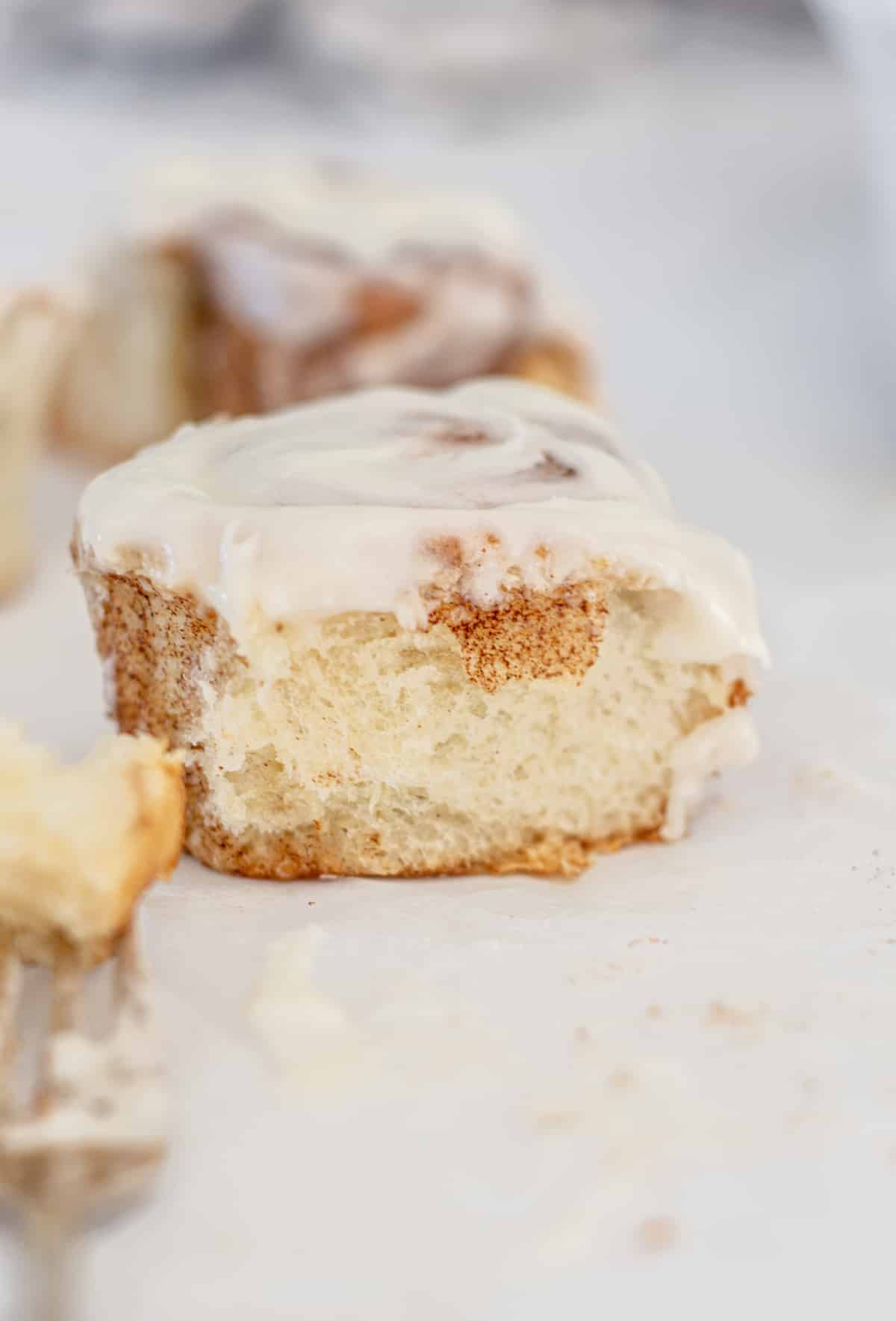 close up of eggless cinnamon roll on a bench.