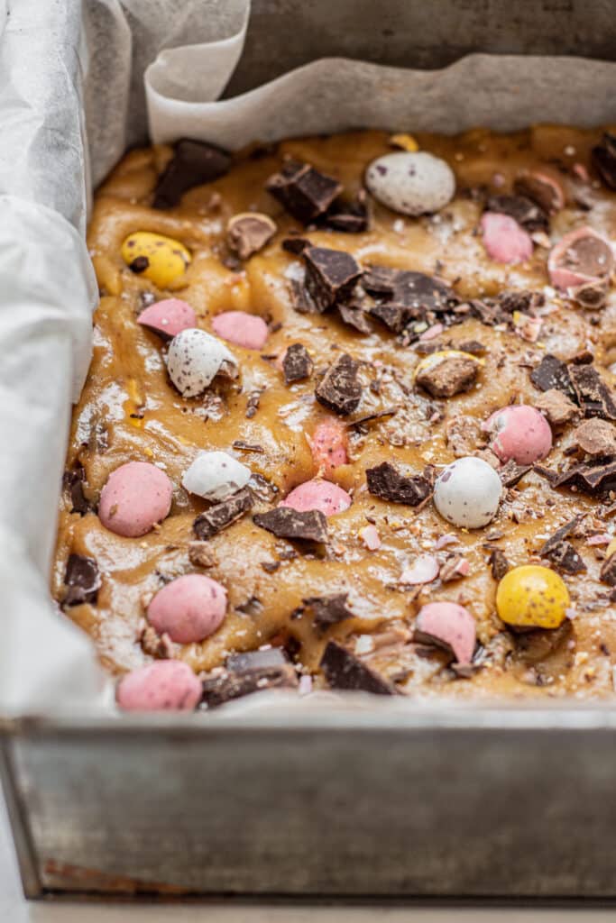 unbaked cookie bar with chopped mini eggs.
