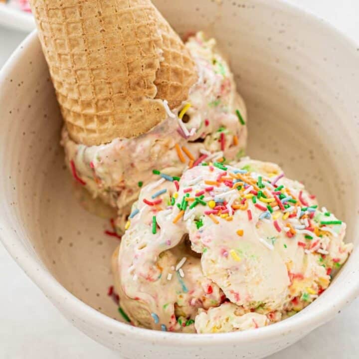 upside down ice cream cone in a bowl with sprinkles.