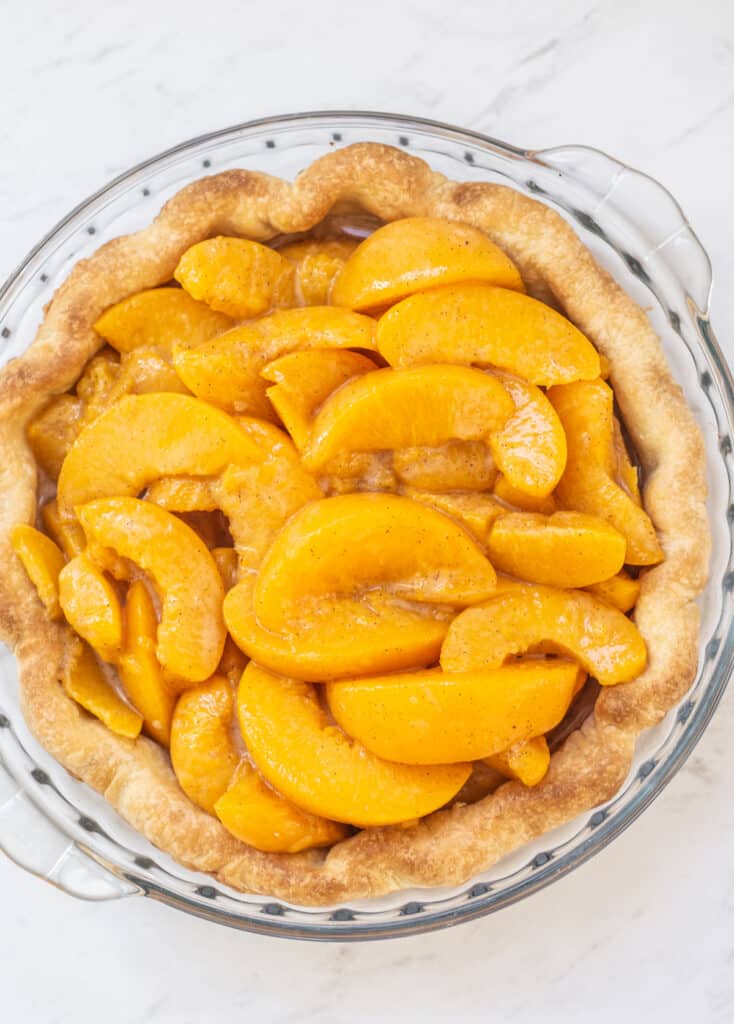 a pie filled with canned peach slices.