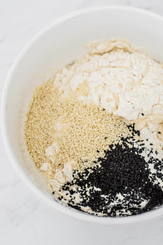 a bowl of flour and sesame seeds.