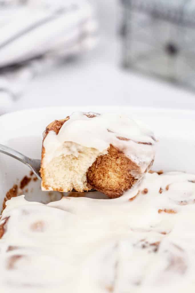 A fork with a slice of cinnamon roll 