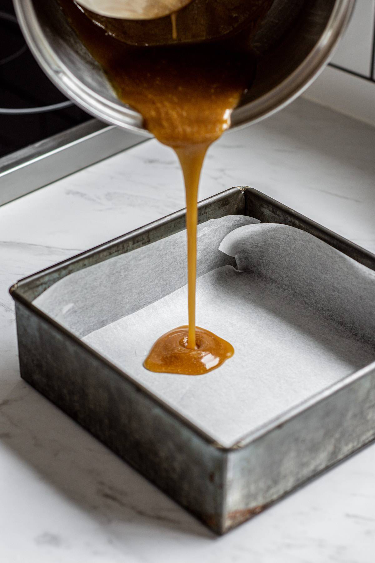 caramel being poured into a tray.