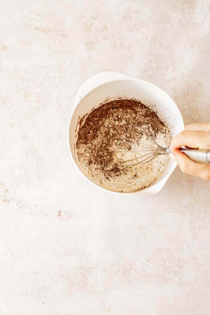 a whisk stirring flour and cocoa.