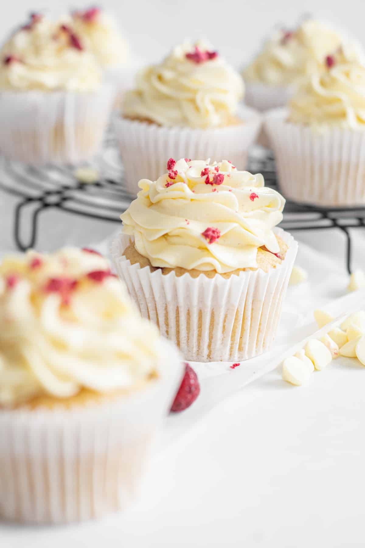 raspberry topped white iced cupcakes.