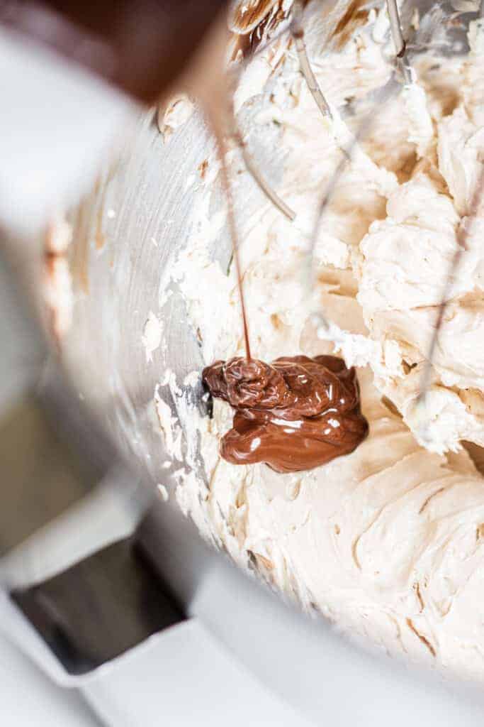 chocolate being drizzled into meringue.