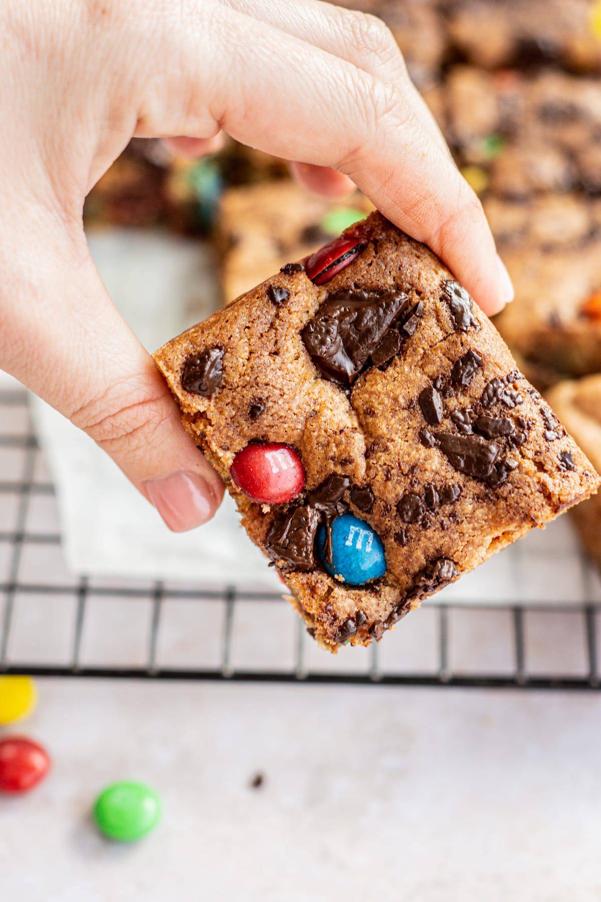 a hand holding a cookie bar.