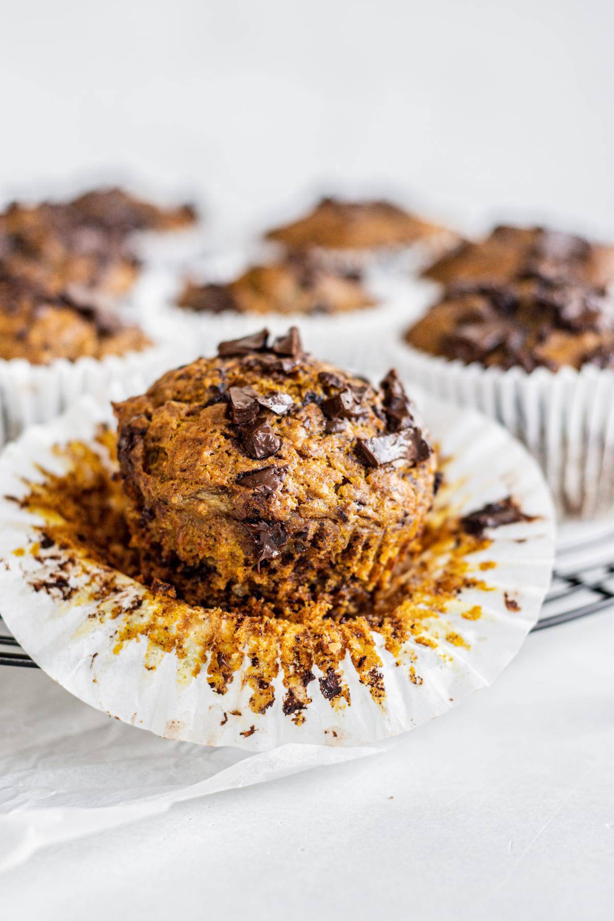 chocolate pumpkin muffin with paper peeled back.