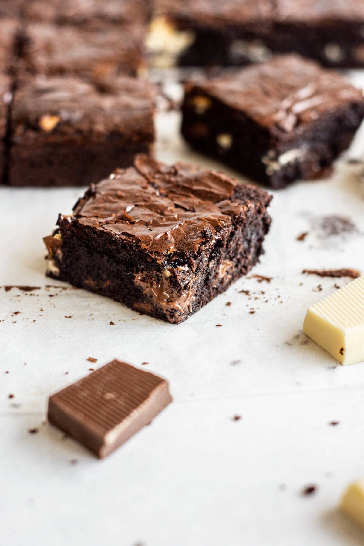 triple chocolate brownie with more brownies in the background.