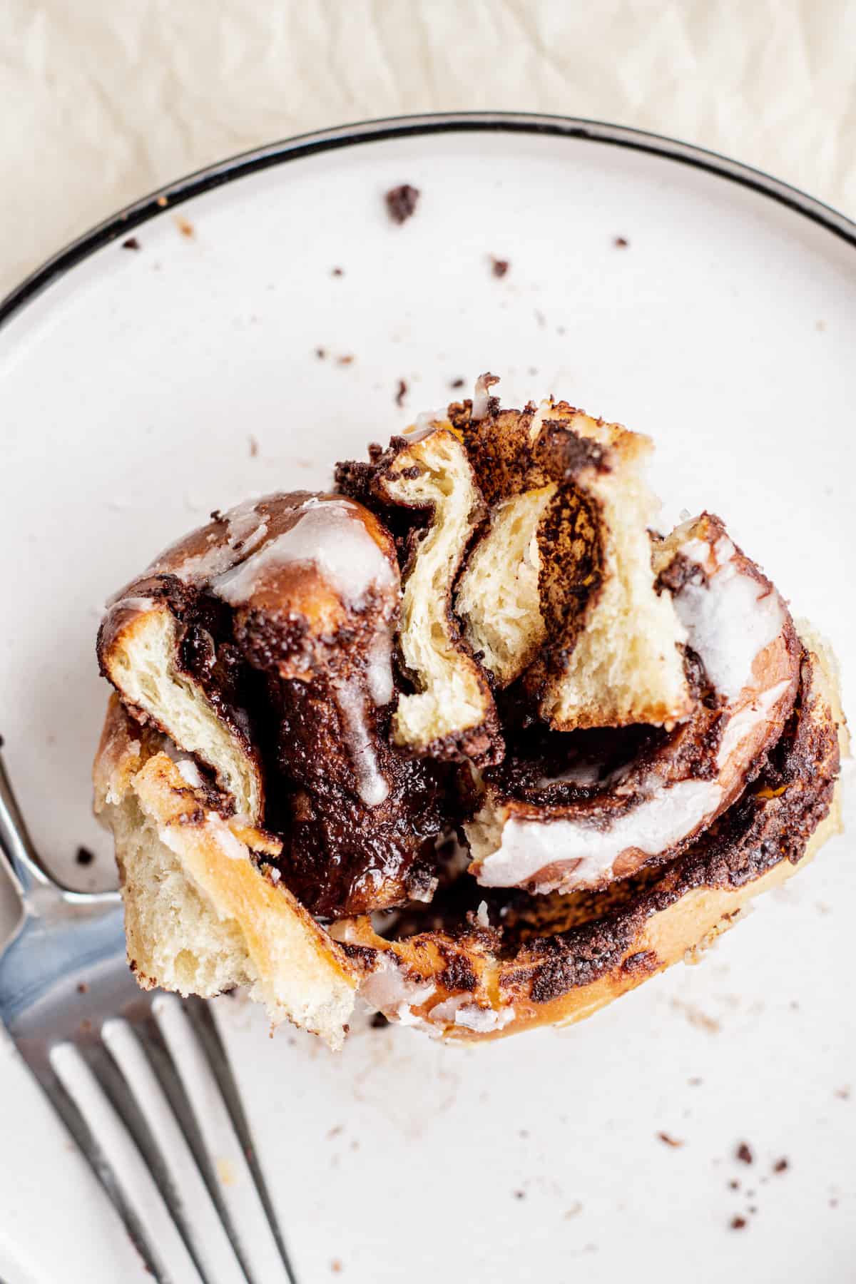 close up of chocolate cinnamon roll on a plate.