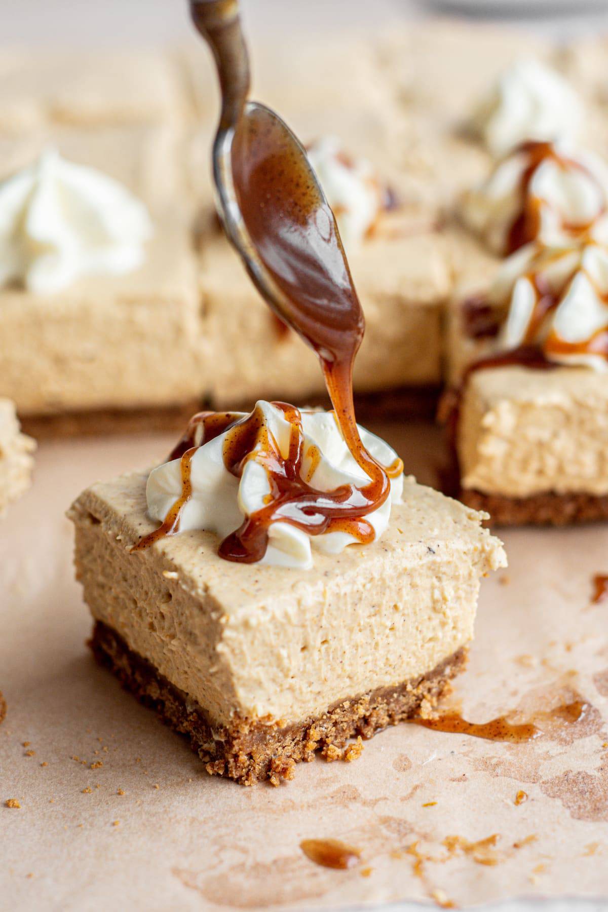 cheesecake bar with caramel being drizzled over.
