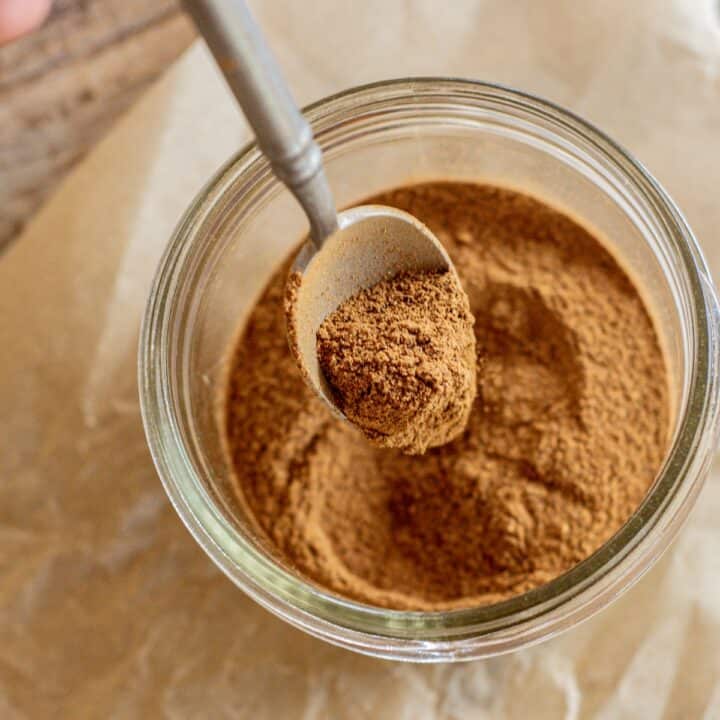 a jar of mixed spices with a spoon.