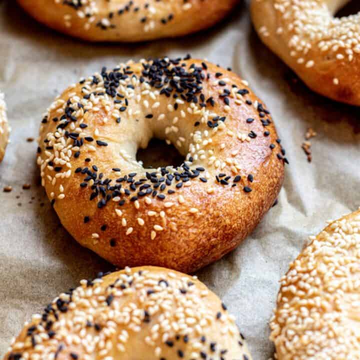 side view of bagels with black sesame seeds.