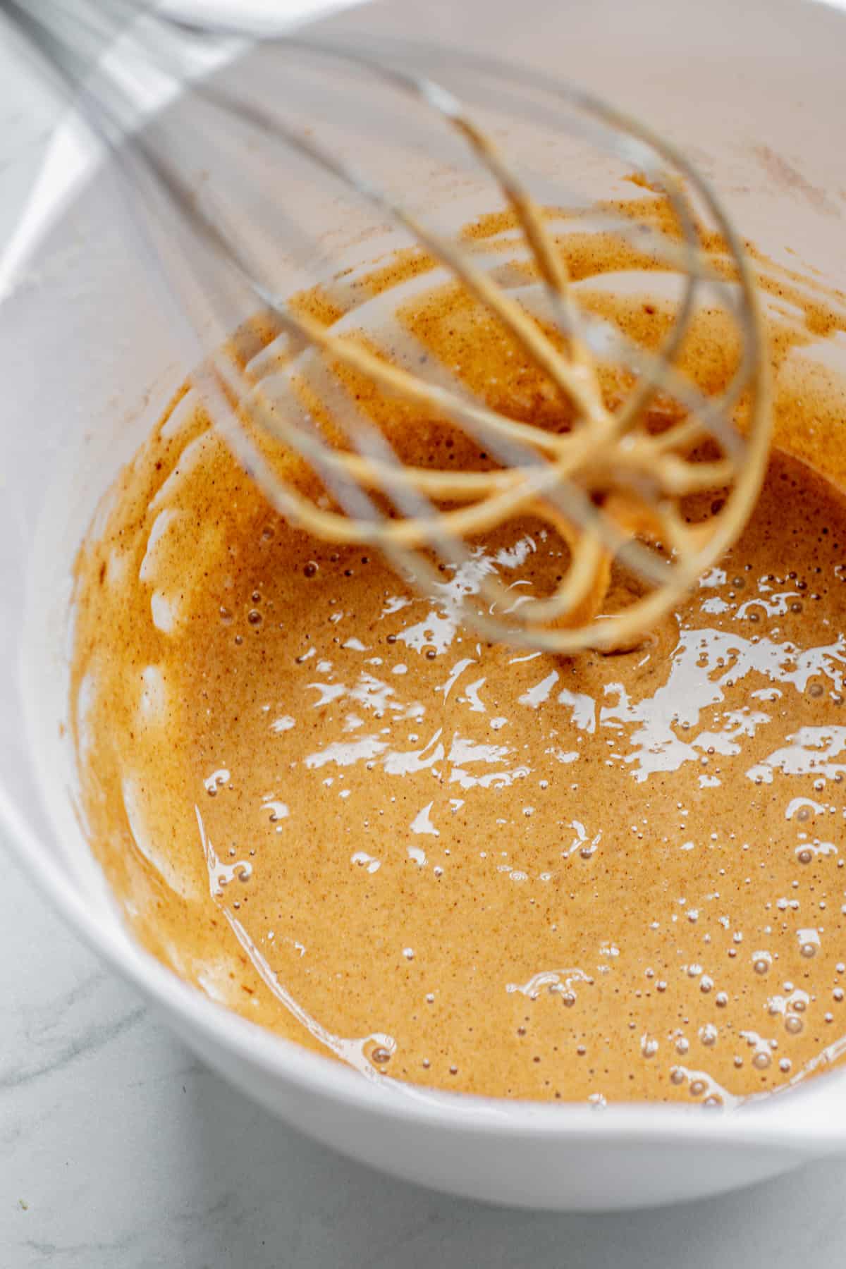 a whisk in egg cinnamon mix.
