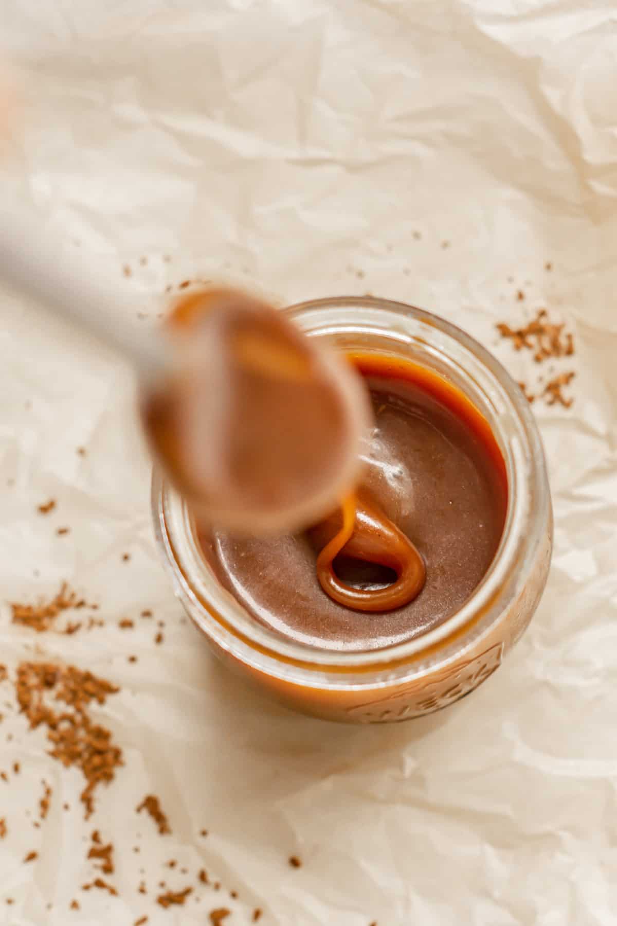 a spoon dripping caramel.