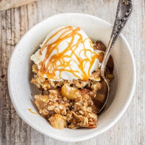 a bowl of apple crisp with ice cream.