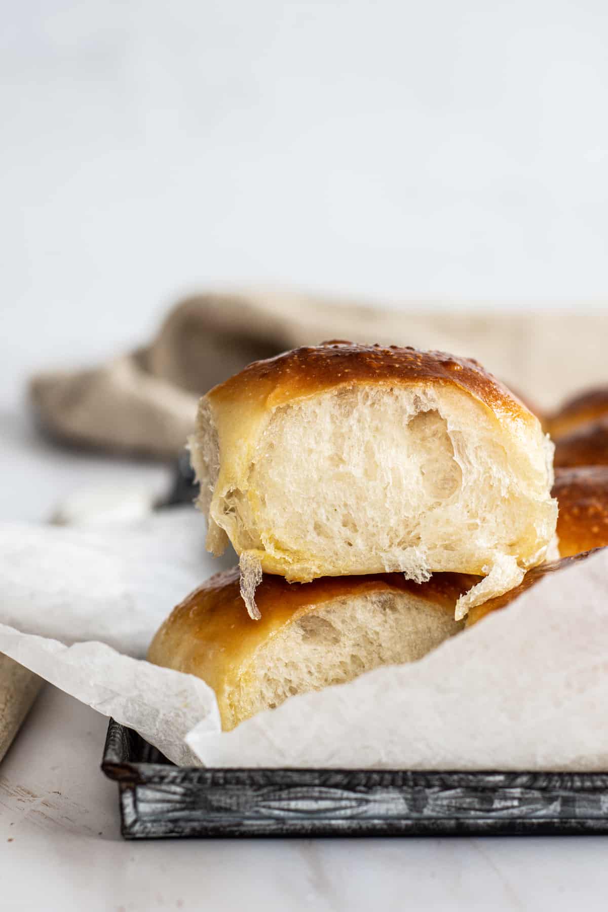 close up of stacked dinner rolls.