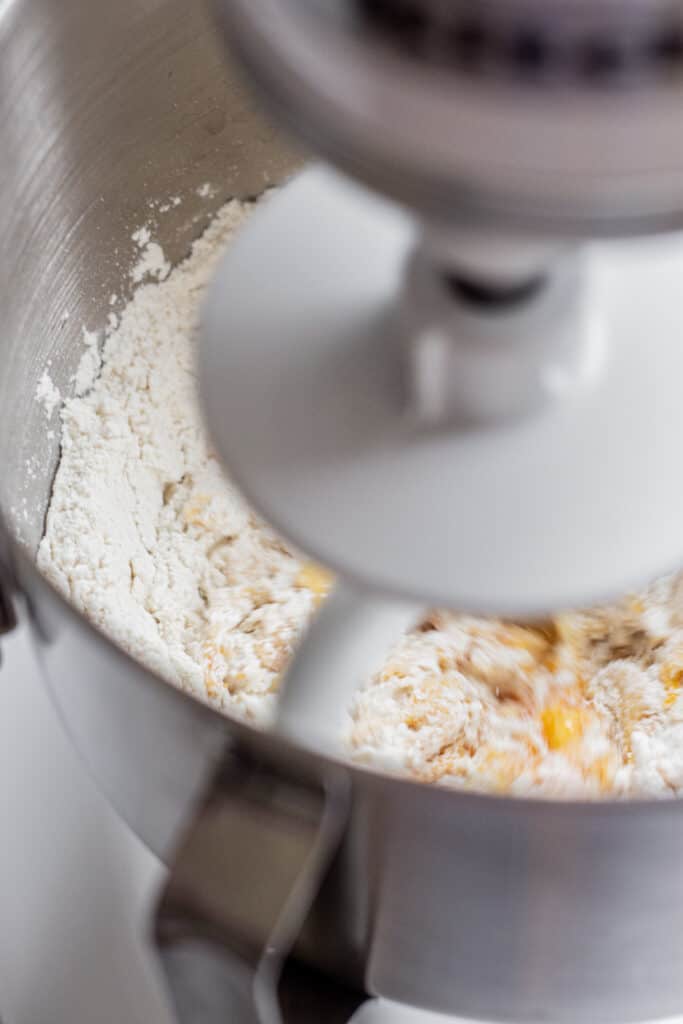 a mixer with egg and flour.