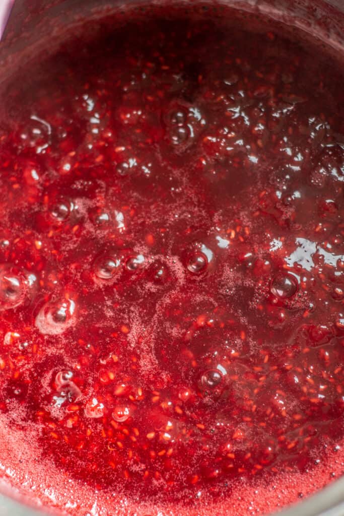 bubbling raspberry sauce in saucepan.