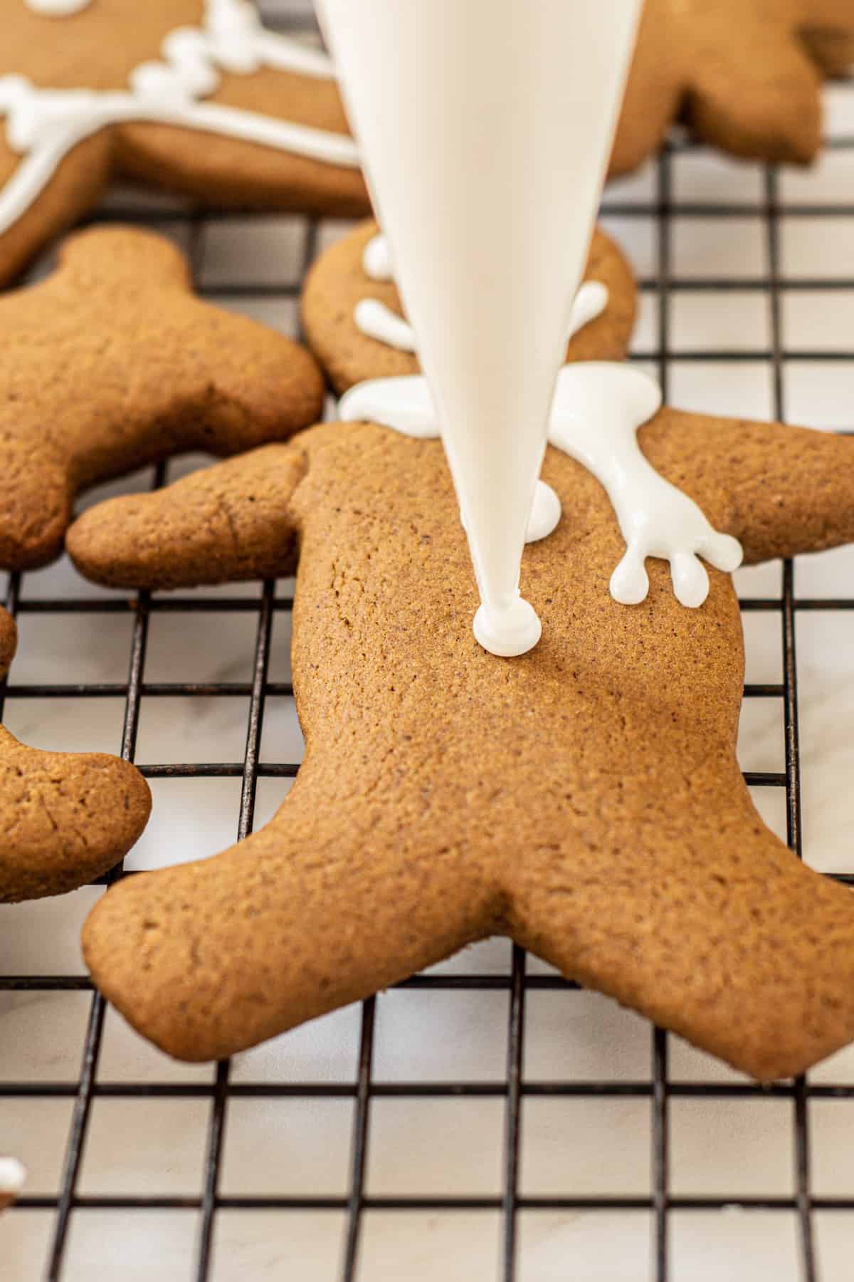icing a gingerbread cookie.