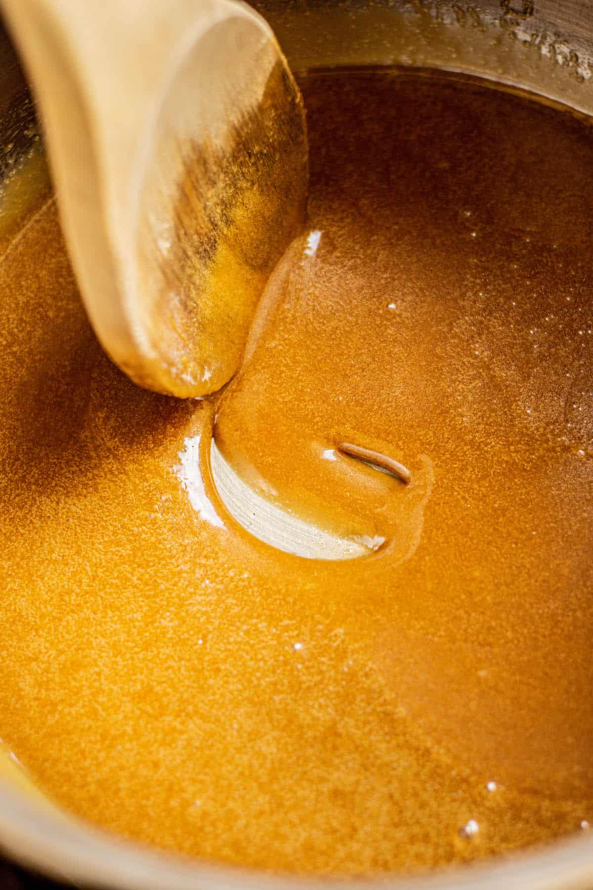 a spoon stirring brown sugar.