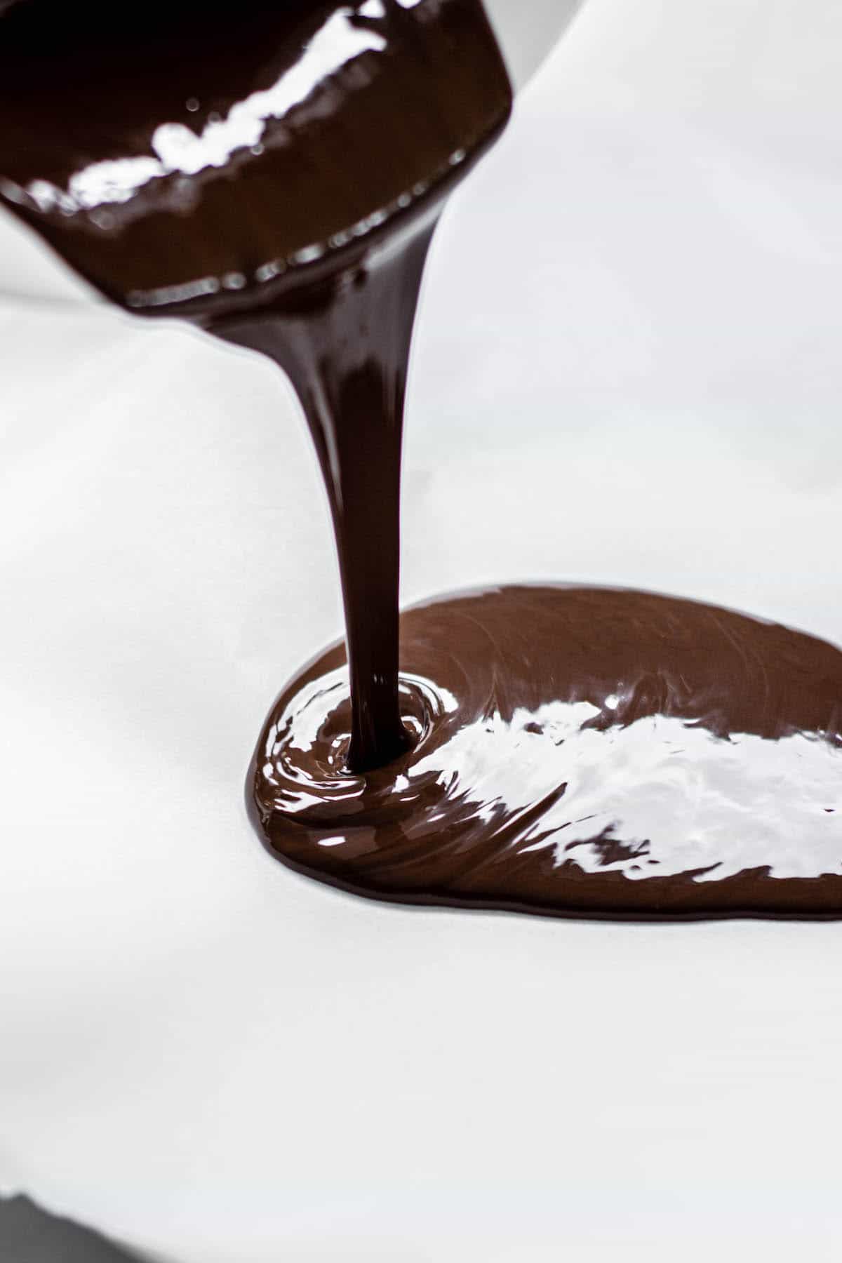 chocolate being poured on baking paper.