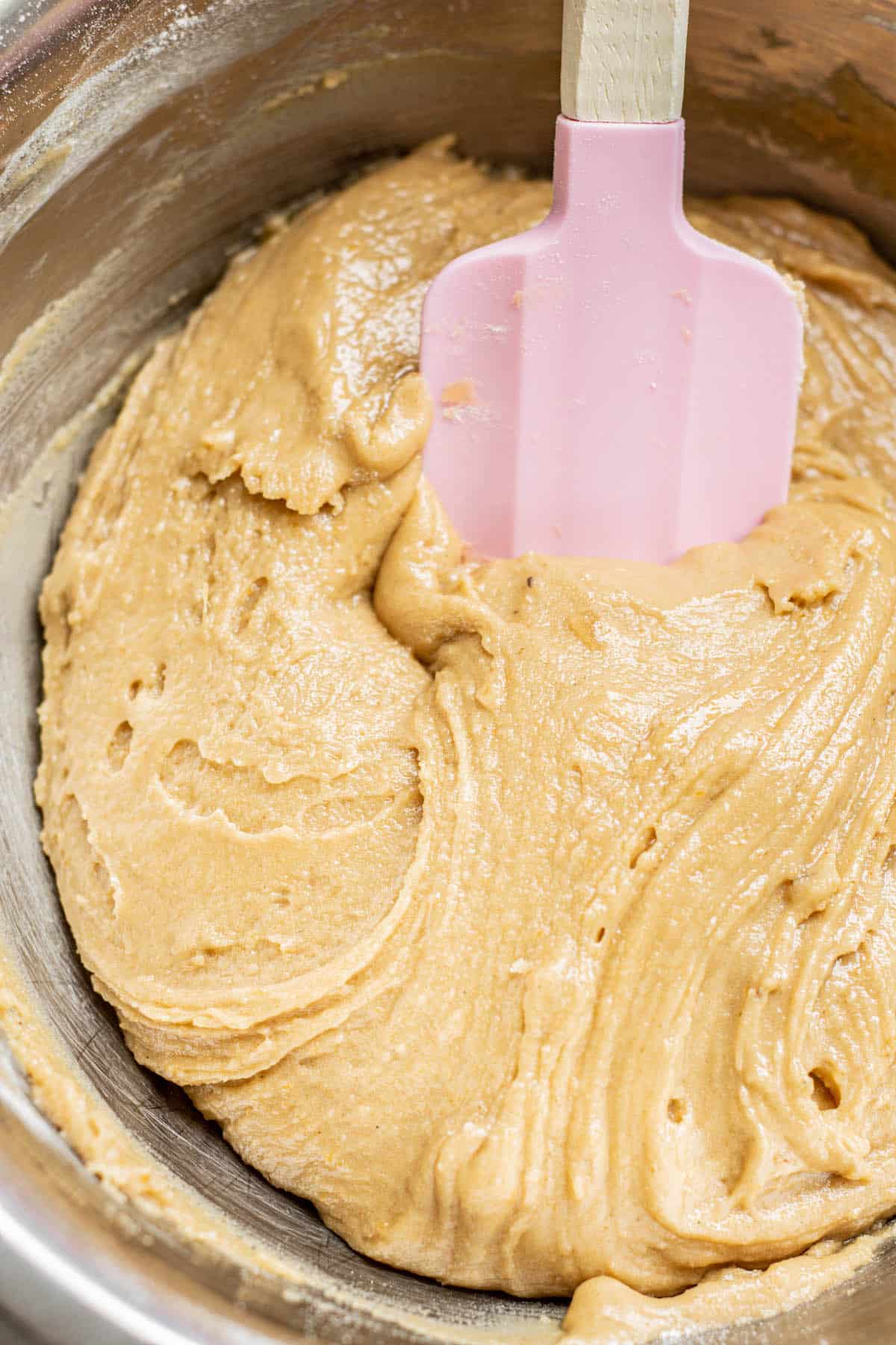cookie dough with a pink spatula.