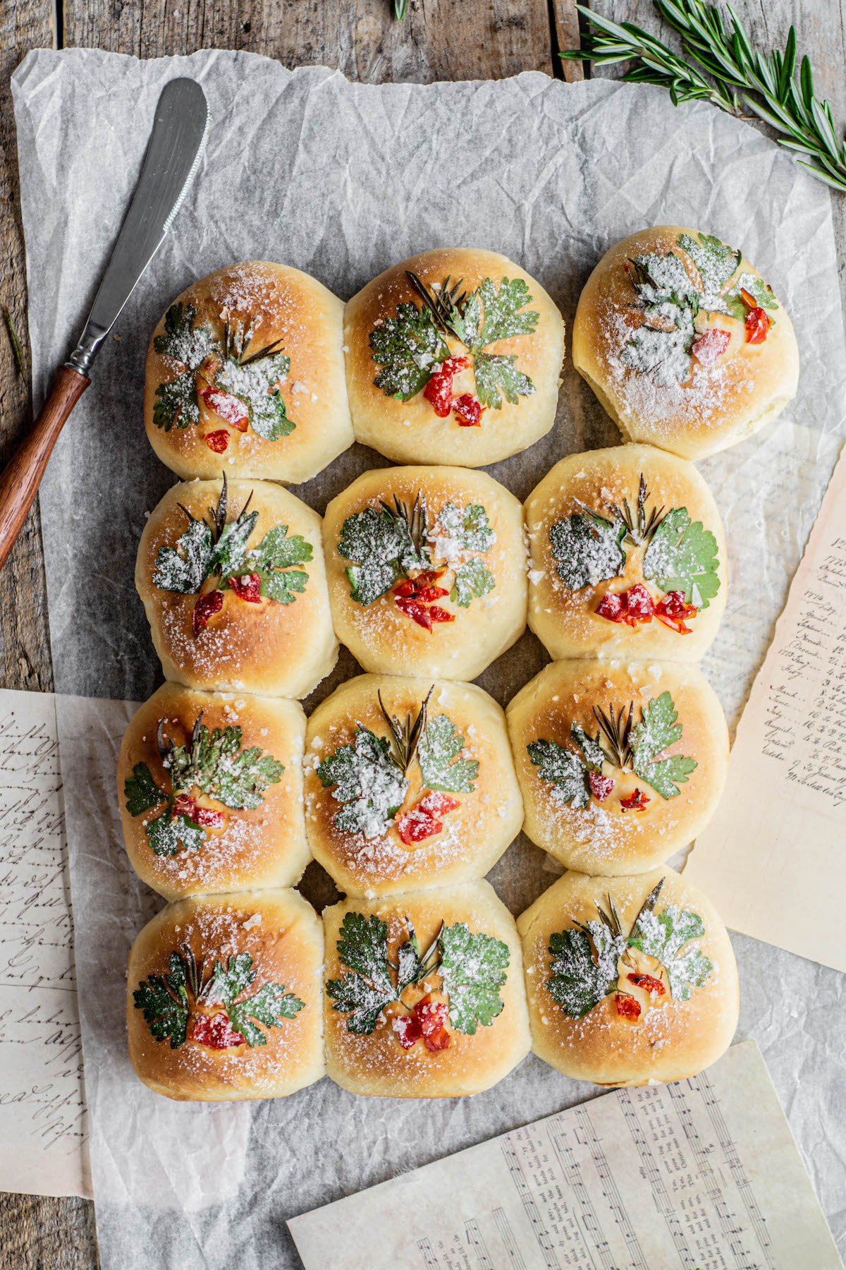 baked dinner rolls decorated with herbs.