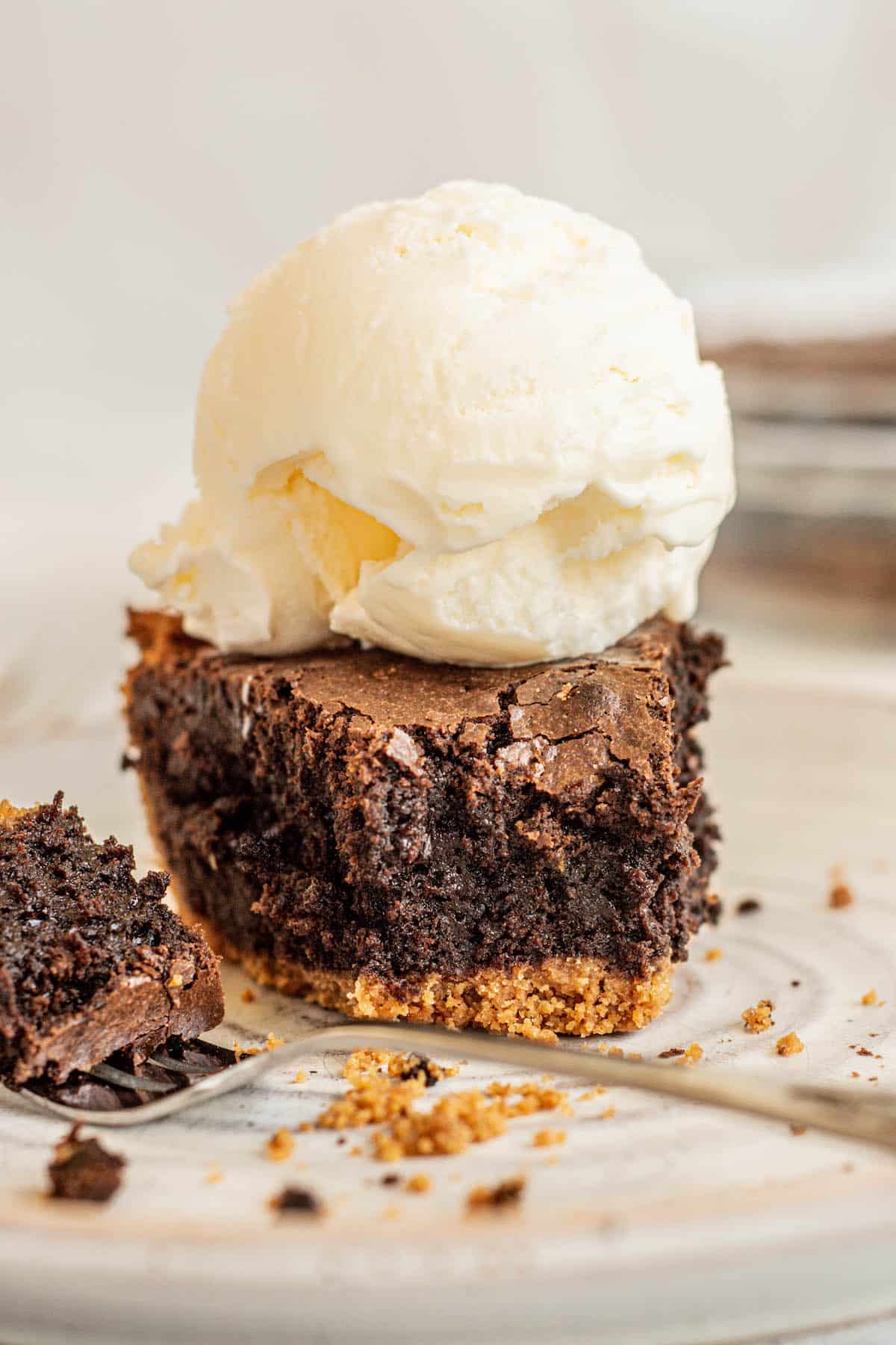 brownie pie piece with ice cream on it.