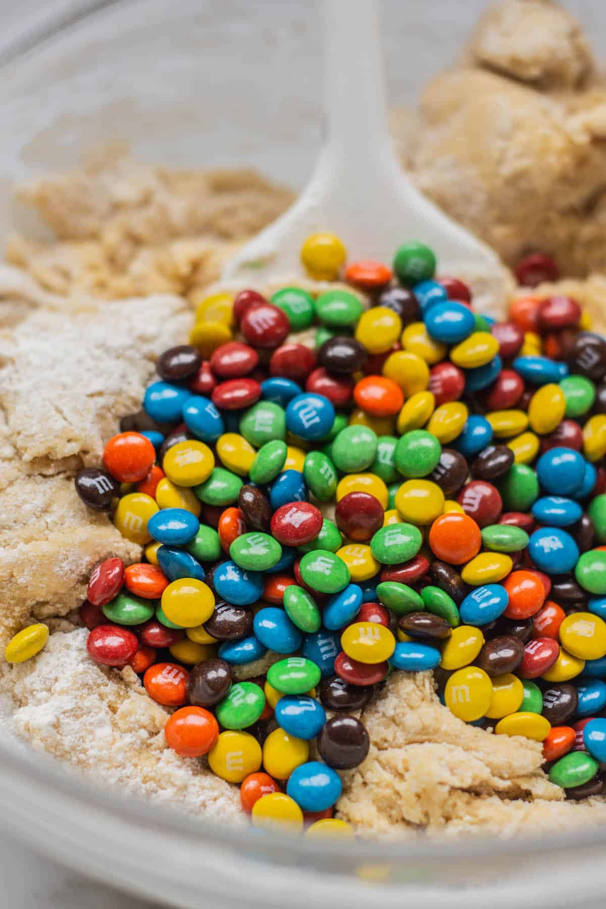 m&ms in a bowl of dough.