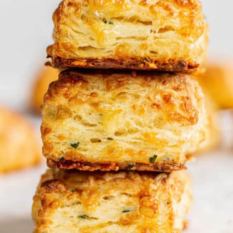 3 stacked easy cheese scones on a bench.