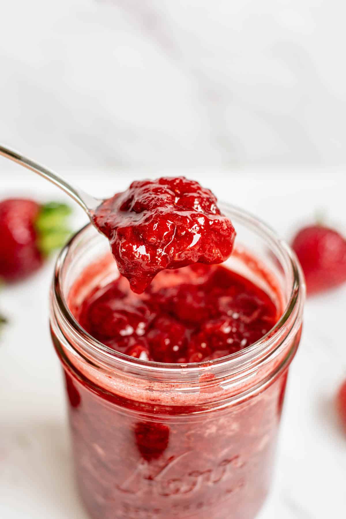 a spoon of thick strawberry compote.